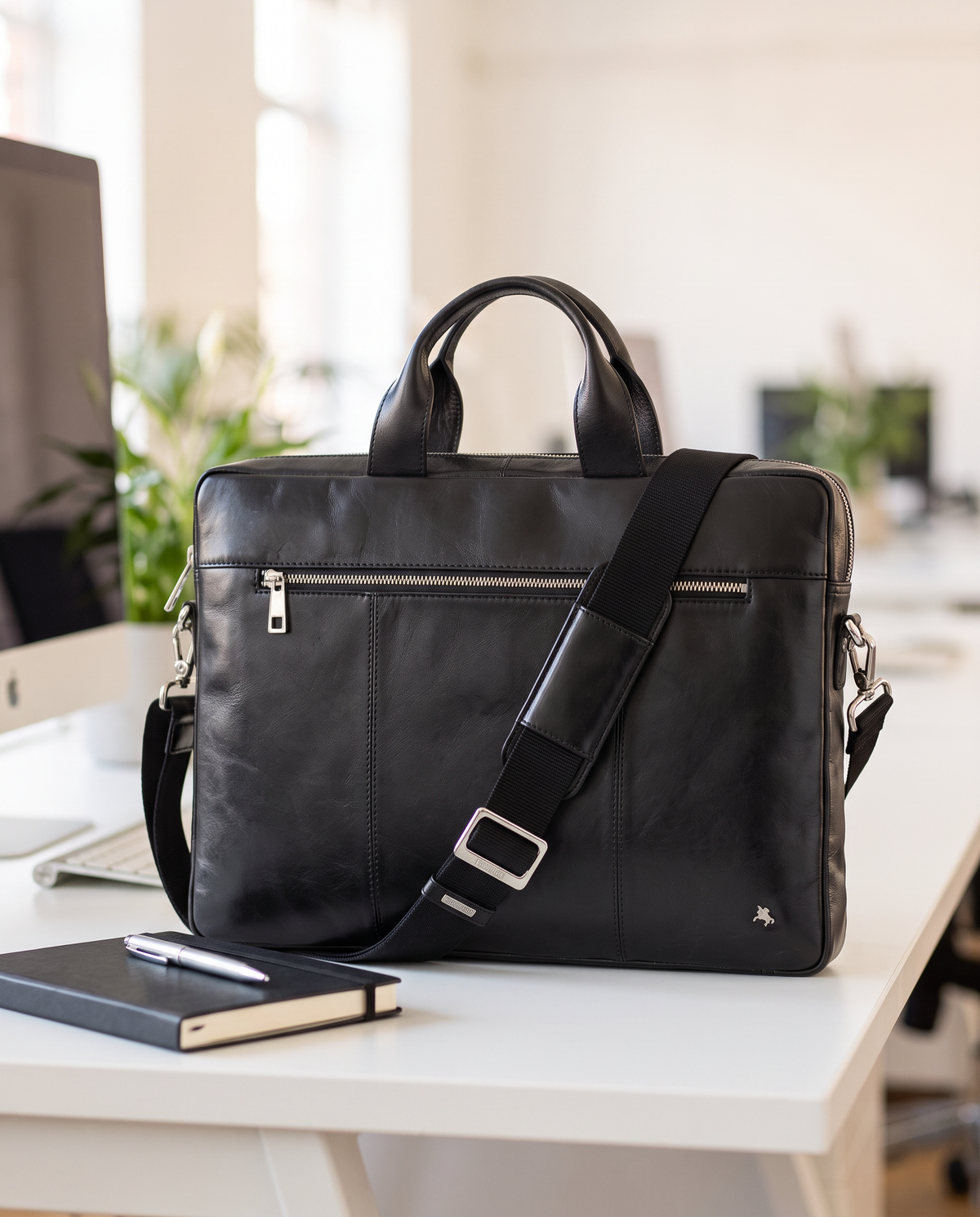 Charles 13" black laptop bag, styled still life
