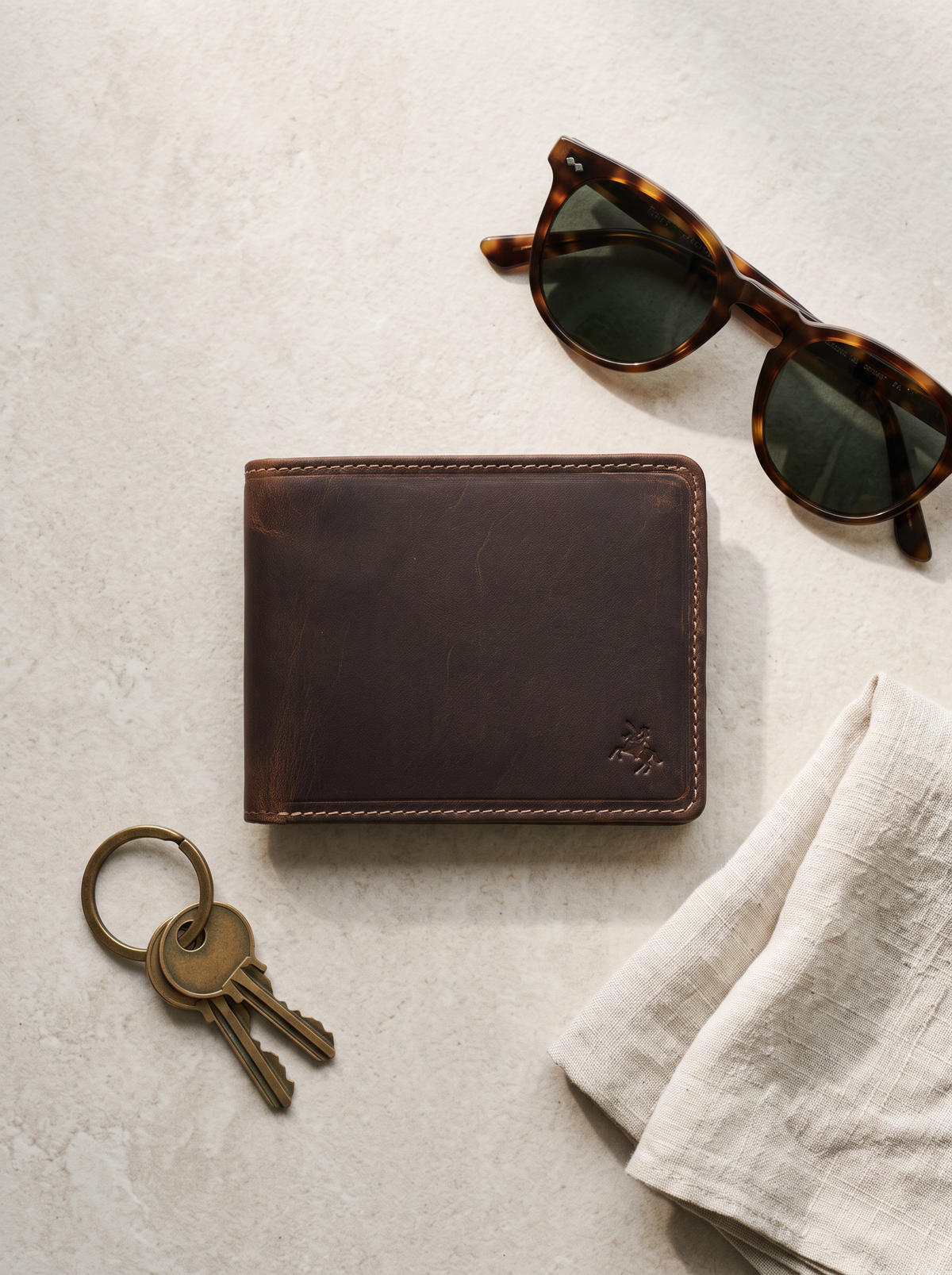 Rocco rich tan wallet on stone with sunglasses and keys
